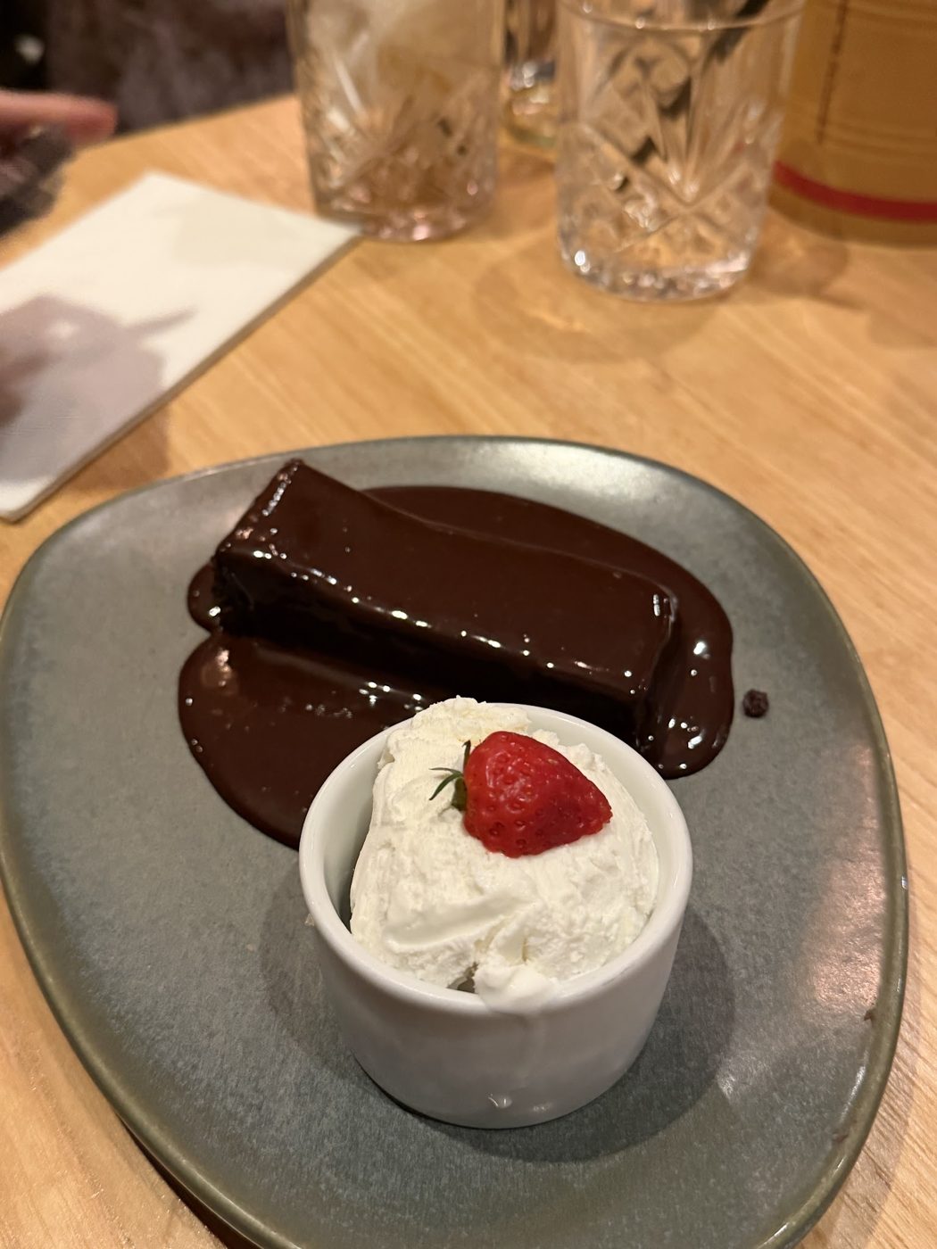 Chocolate dessert with cream and a strawberry