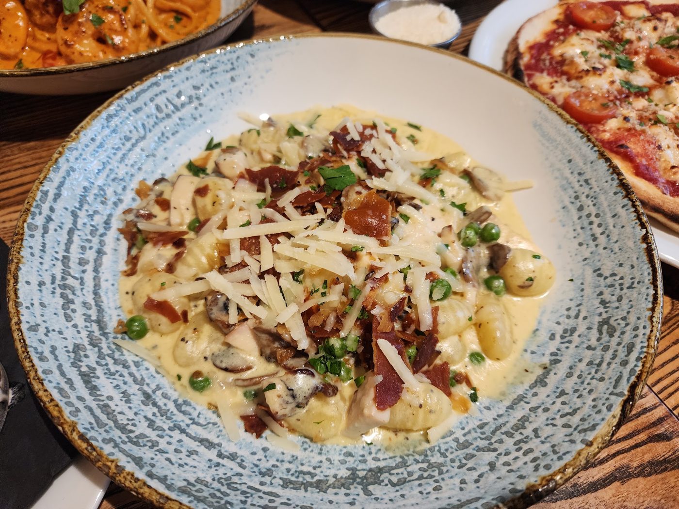 Creamy pasta with parmesan in a blue bowl